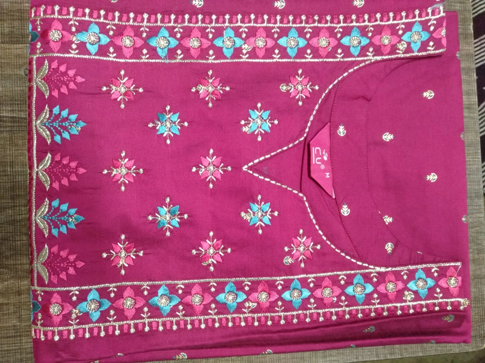 Embroidered magenta garment